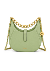 Green handbag with gold chain and smiley face charm on a white background