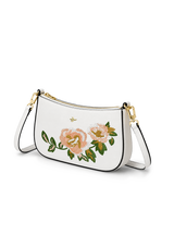 White handbag with floral embroidery on a white background