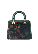 Green handbag with floral pattern on a white background