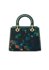 Green handbag with floral pattern on a white background